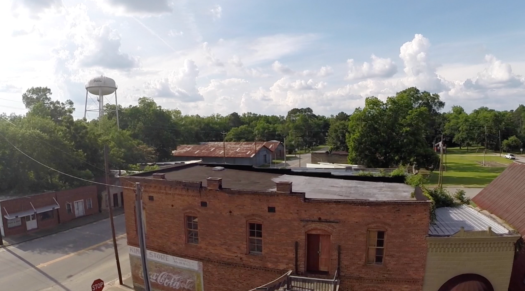 Aerial view of downtown Pitts, Georgia with historic brick buildings and water tower